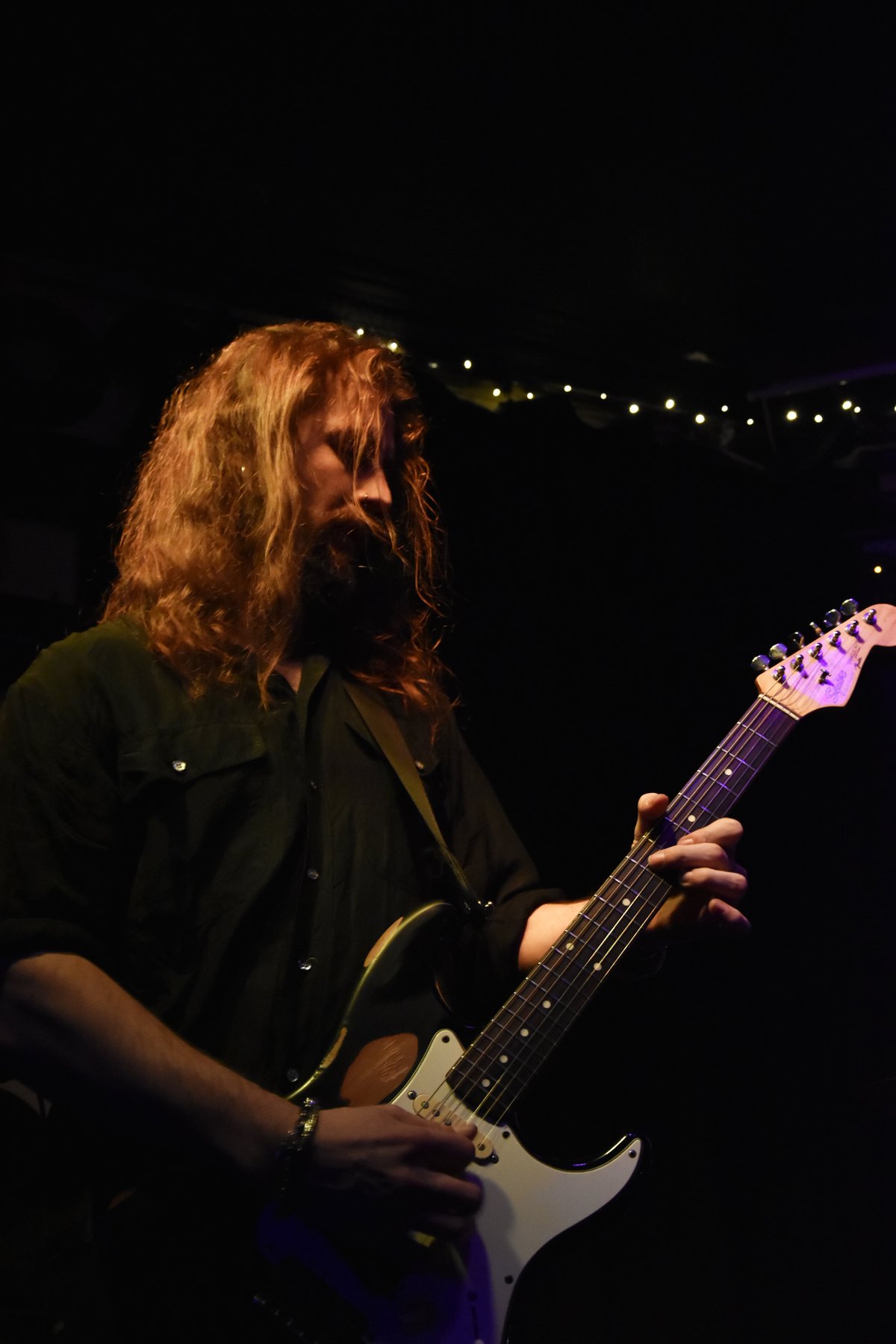Cash Ulrich playing guitar during a live set