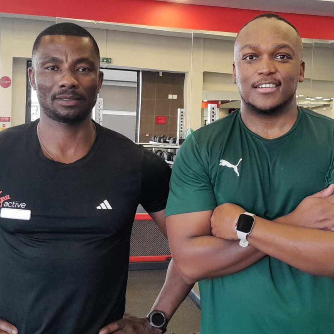 Andrew Ntlebi with a training partner at the gym